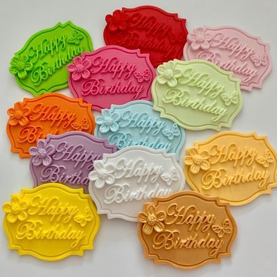 Pastel sugar plaques reading Happy Birthday