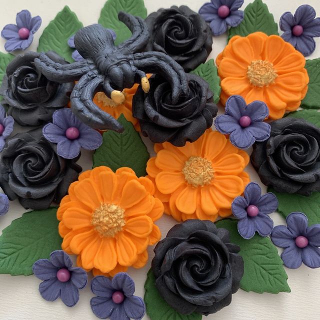 Black sugar roses, orange and purple flowers with a sugar spider