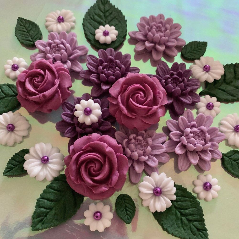 Close-up of handmade sugar roses, dahlias and daisies in shades of purple and pink